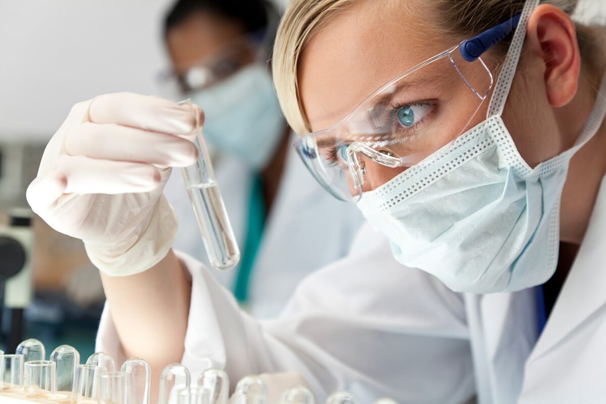 Scientist examining a test tube in an advanced skincare R&D laboratory.